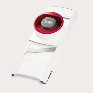 The Zyliss 4-in-1 Slicer & Grater in white and red, with a stainless steel blade and hand guard, sits on a light background—ideal for fast slicing or grating in any kitchen. 
