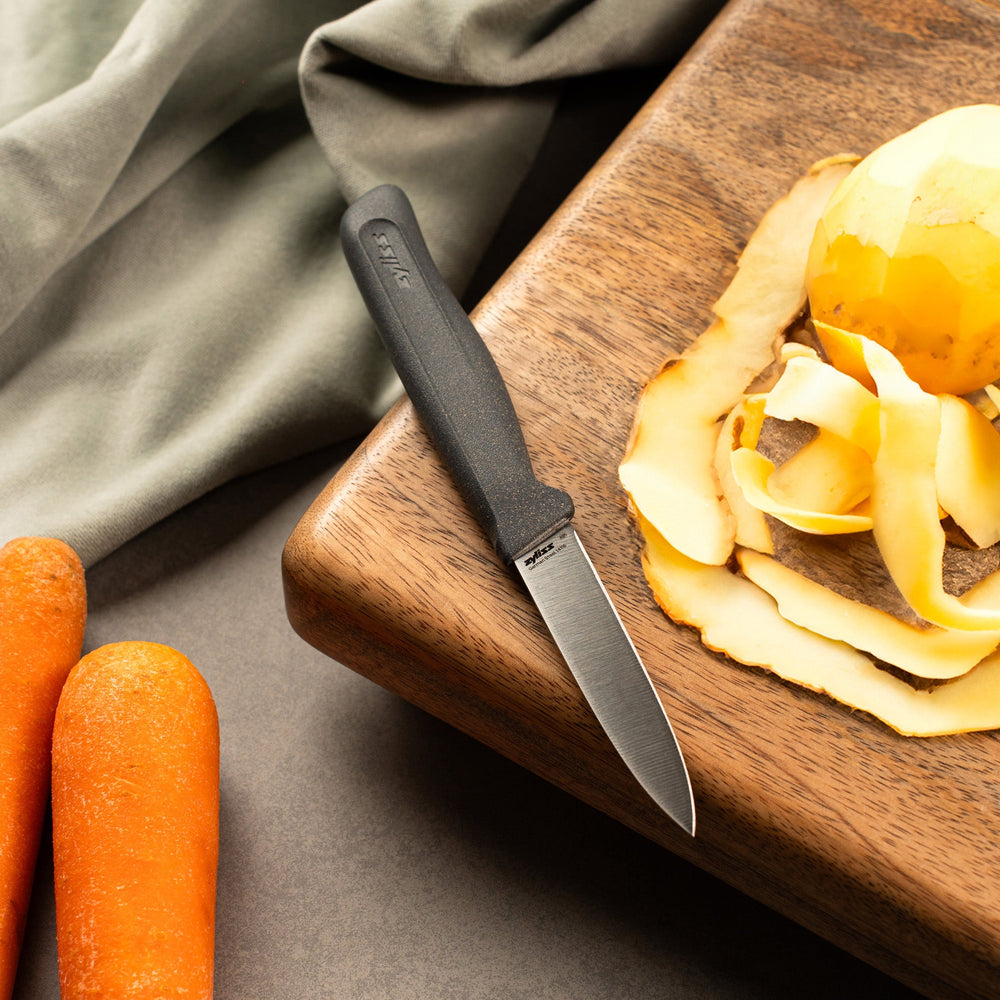 The Zyliss Paring Knife 9cm / 3½ features a shiny silver blade and an eco-friendly handle, shown vertically against a plain off-white background. 
