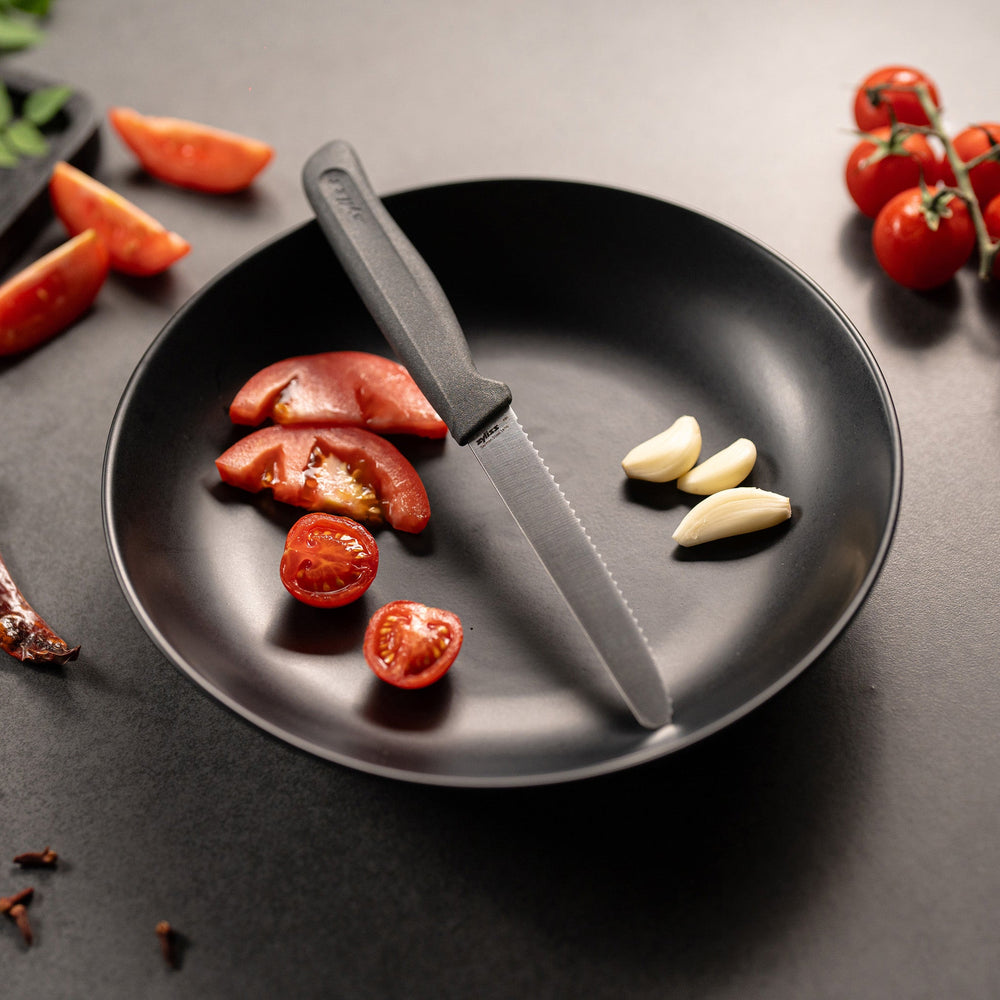 The Zyliss Tomato Knife Serrated 11cm / 4½ features a silver serrated blade and an eco-friendly handle, shown against a plain white background. 