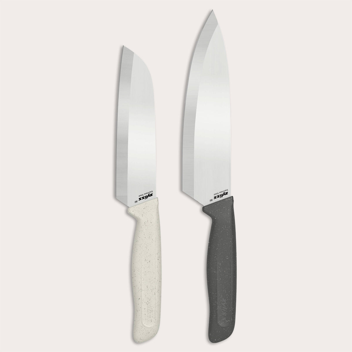 The Zyliss Classic 2 Piece Chef & Santoku Knife Set features two kitchen knives with shiny stainless steel blades—one with a sleek white handle and the other with a black handle. Both the chef knife and santoku blade stand upright against a plain, light background.