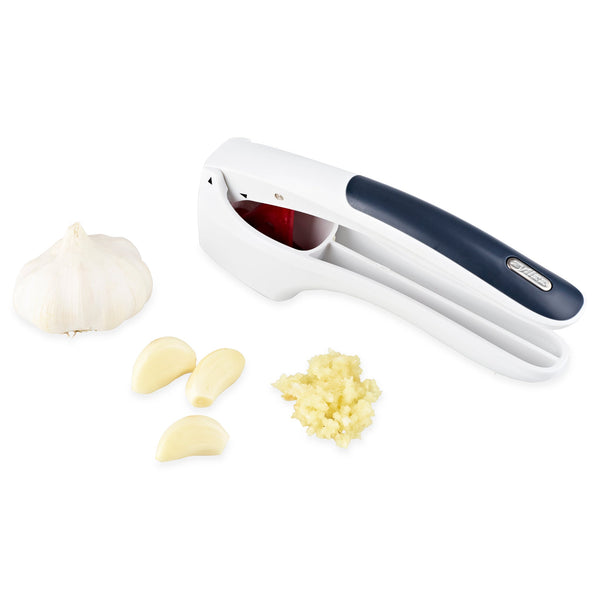 The Zyliss Easy Clean Garlic Press, featuring ergonomic handles and a sleek black finish, is shown with a garlic bulb, peeled cloves, and minced garlic on a white background. This tool is also dishwasher safe for easy cleaning. 
