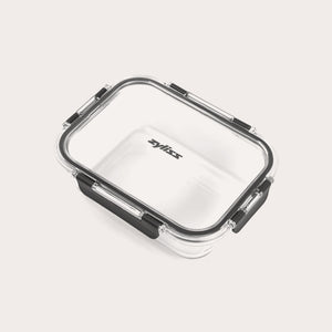 A rectangular clear Zyliss Glass Container for meal prep features a transparent lid with four black locking clips, Zyliss printed in black on the lid, all shown against a plain light background. #1.05L/1.1qt