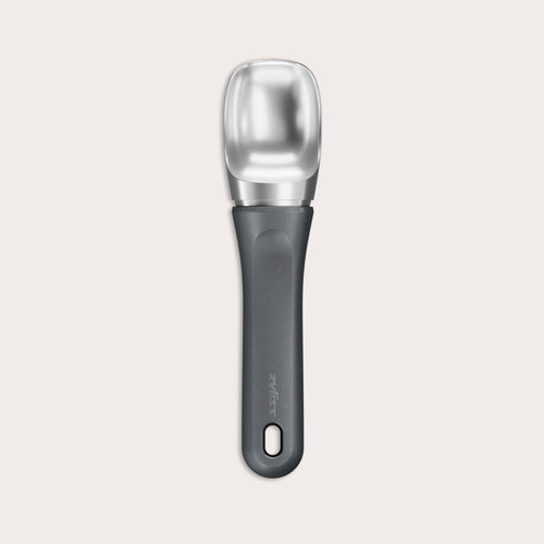 The Zyliss Ice Cream Scoop, featuring a wide deep bowl and eco-friendly handle, is displayed against a plain light background. 