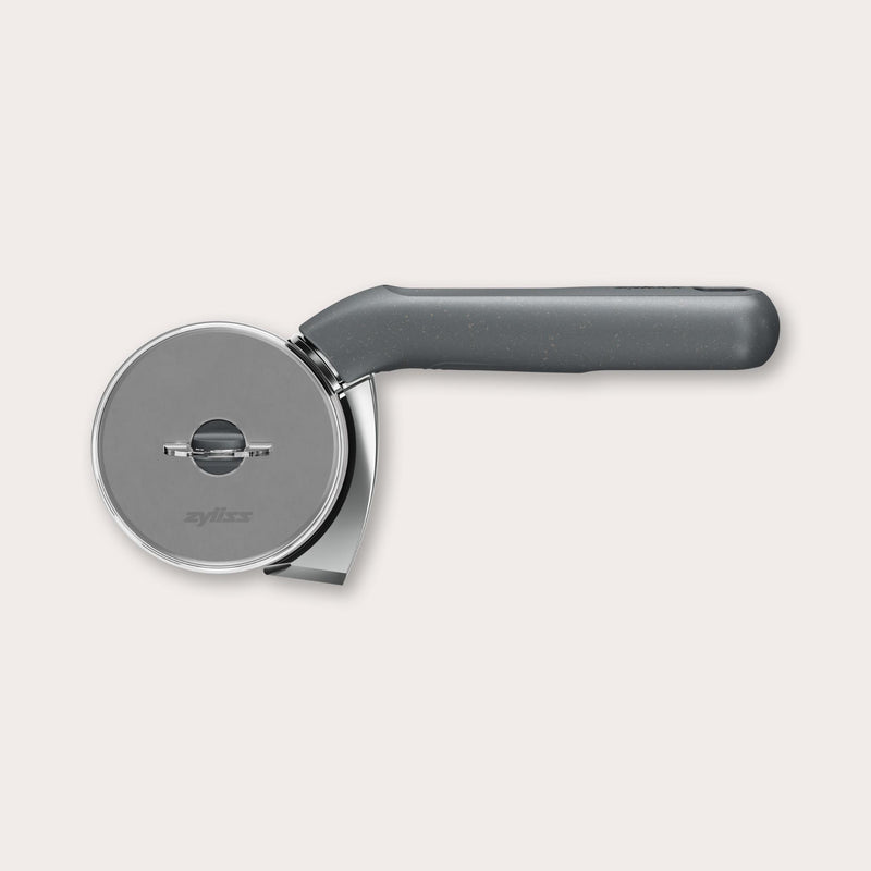 The Zyliss Pizza & Pastry Cutter features a round metal blade and an ergonomic handle, shown against a plain white background. 