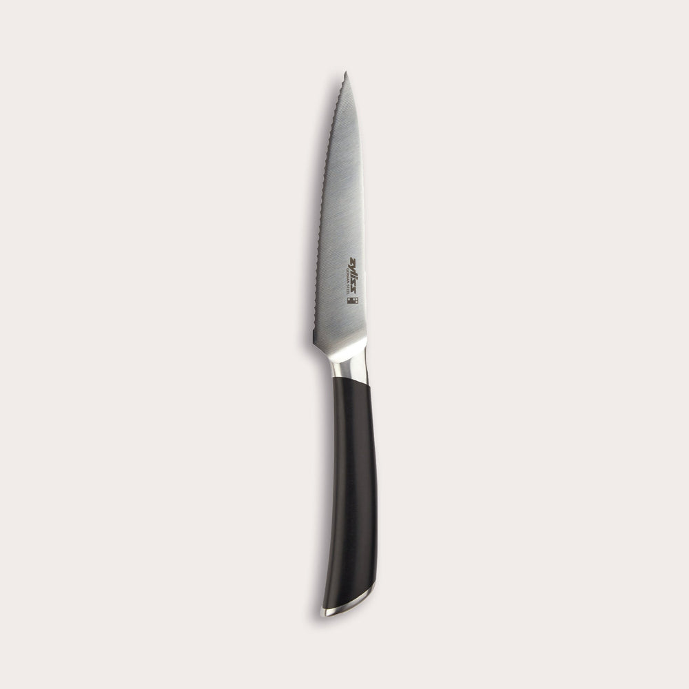 The Zyliss Comfort Pro Serrated Paring Knife 11cm, featuring a German stainless steel blade and ergonomic black handle, is displayed vertically against a plain light background. 