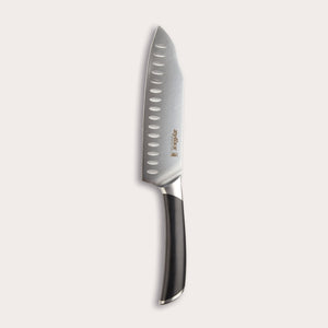 The Zyliss Comfort Pro Santoku Knife 18cm/7 features German stainless steel, a black ergonomic handle, and oval blade indentations, displayed against a light background. 